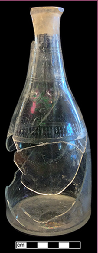 Fragmented and mended colorless glass decanter with a simple cut swag motif.